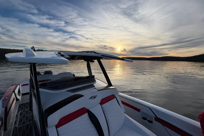 Slide: The Image of 2022 Sunsation 32 CCX boat with Mercury Verado outboard engine, red and black design. - 16