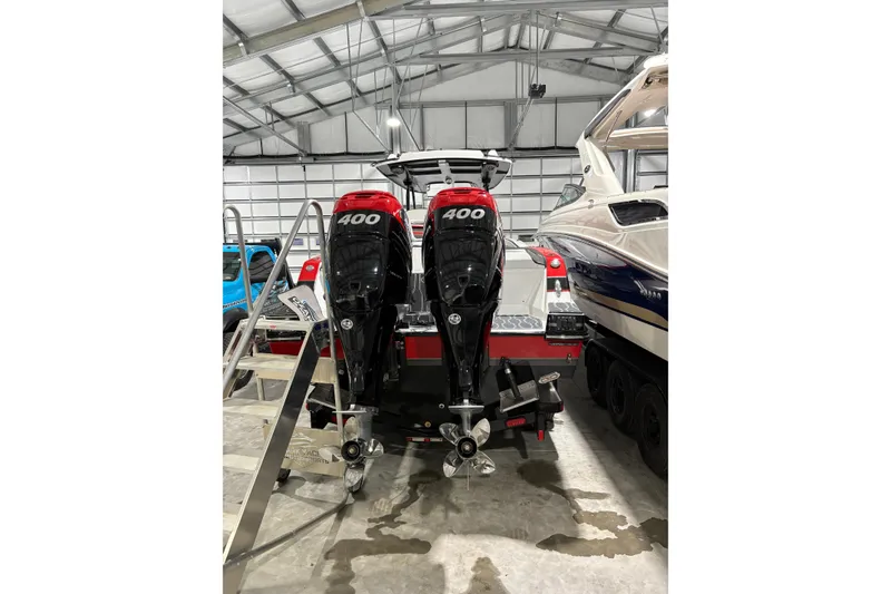 Slide: The Image of 2022 Sunsation 32 CCX boat with twin 400 horsepower outboard engines, parked outdoors. - 6