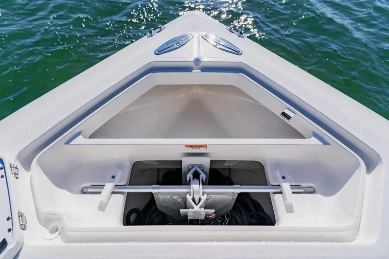Slide: The Image of 2025 SeaVee 370Z boat interior with open storage compartments and cushioned seating. - 12