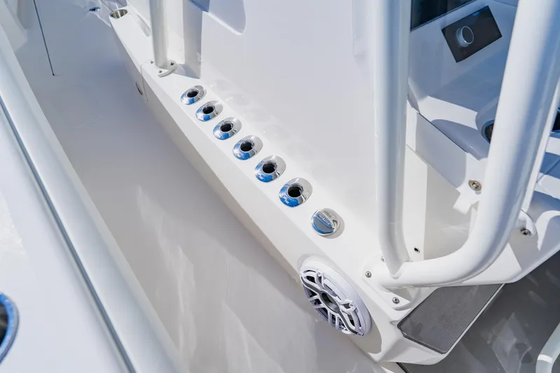 Slide: The Image of 2025 SeaVee 370Z boat deck with triple engines and sleek seating on water. - 25