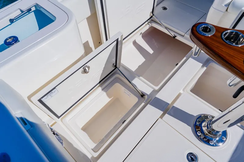 Slide: The Image of 2025 SeaVee 370Z boat interior with open storage compartments and rod holders. - 28
