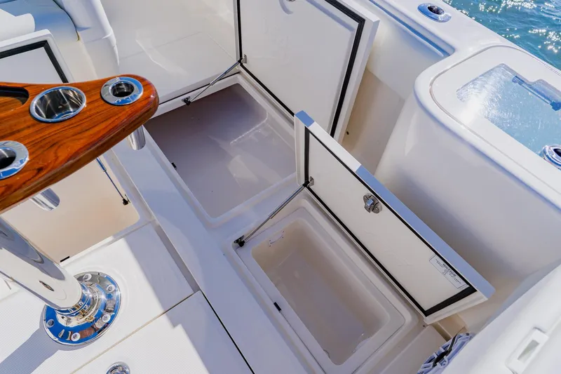 Slide: The Image of Triple Mercury outboard engines on a 2025 SeaVee 370Z boat, floating on clear water. - 29