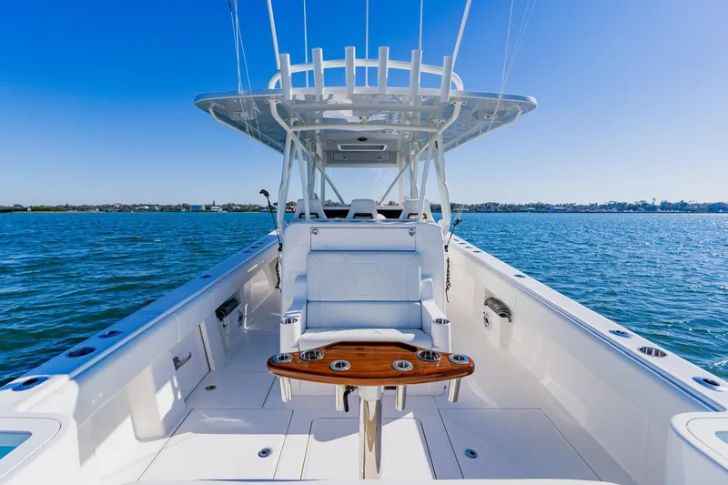 Slide: The Image of 2025 SeaVee 370Z boat interior with white seating and clear blue sky. - 38
