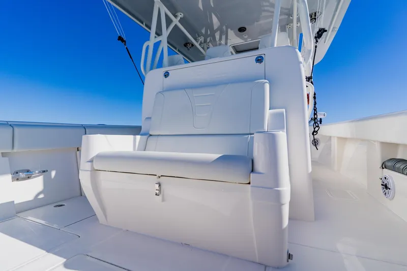 Slide: The Image of 2025 SeaVee 370Z boat interior with storage compartment and cup holders on a sunny day. - 39