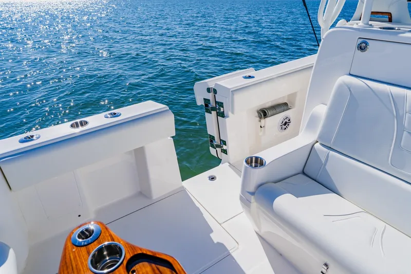 Slide: The Image of 2025 SeaVee 370Z boat deck with speakers and measuring scale, under clear blue sky. - 44