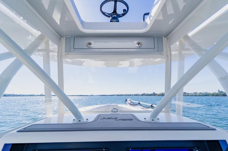 Slide: The Image of Interior view of 2025 SeaVee 370Z boat, showcasing helm and open sky hatch. - 47