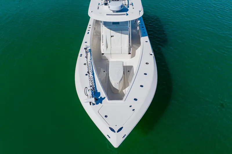 Slide: The Image of 2025 SeaVee 370Z boat cruising on clear blue water, leaving a wake behind. - 5