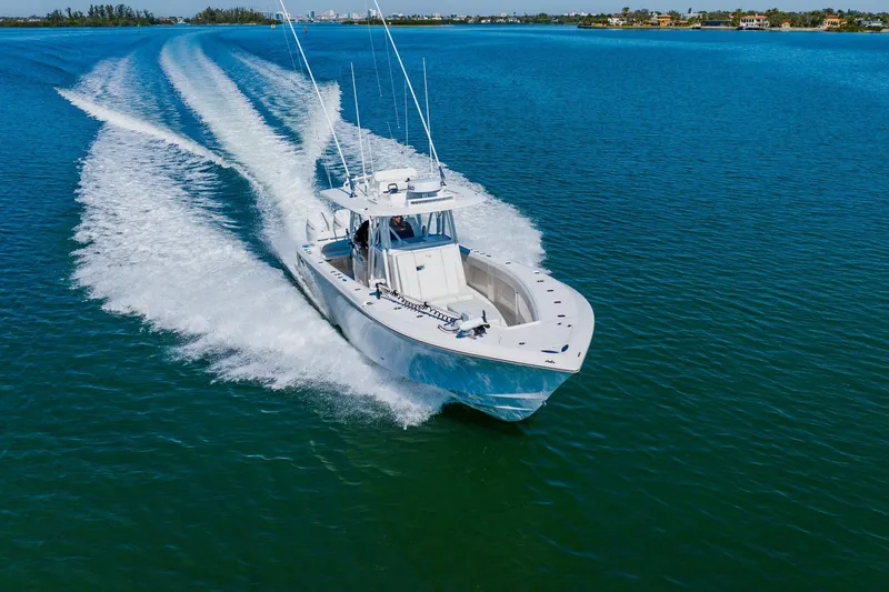 Slide: The Image of 2025 SeaVee 370Z boat cruising on clear blue water, showcasing triple engines. - 6