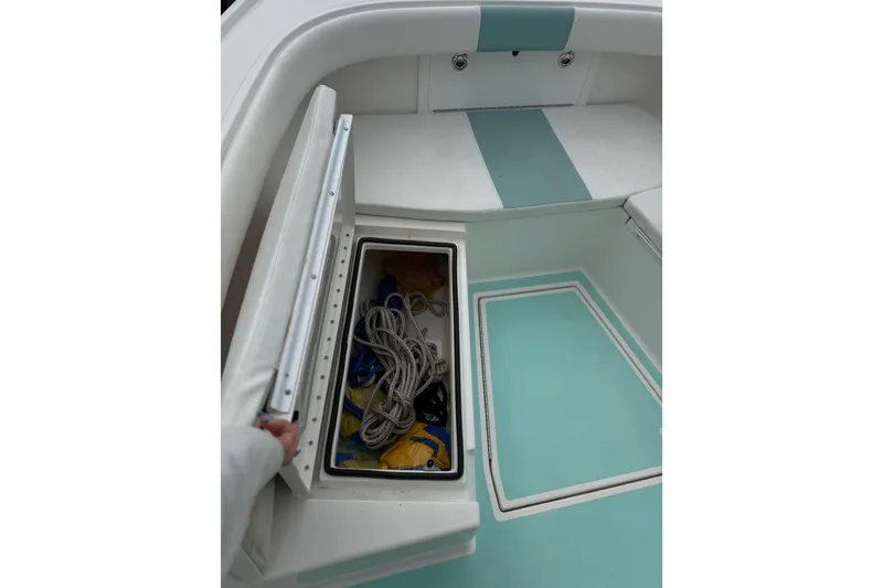 Slide: The Image of 2015 Albury Brothers 23 Center Console boat with open storage compartment and ropes. - 13