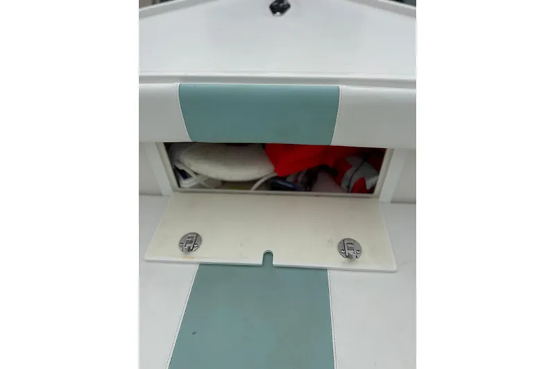 Slide: The Image of Storage compartment on a 2015 Albury Brothers 23 Center Console boat, partially open. - 14