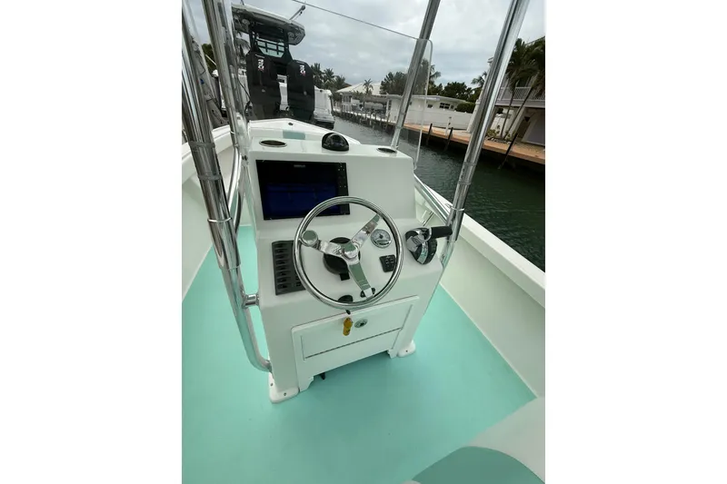 Slide: The Image of 2015 Albury Brothers 23 Center Console boat interior with steering wheel and controls. - 7