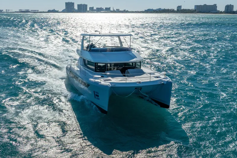 Slide: The Image of 2021 Leopard 53 Powercat cruising on sparkling blue ocean waters. - 0