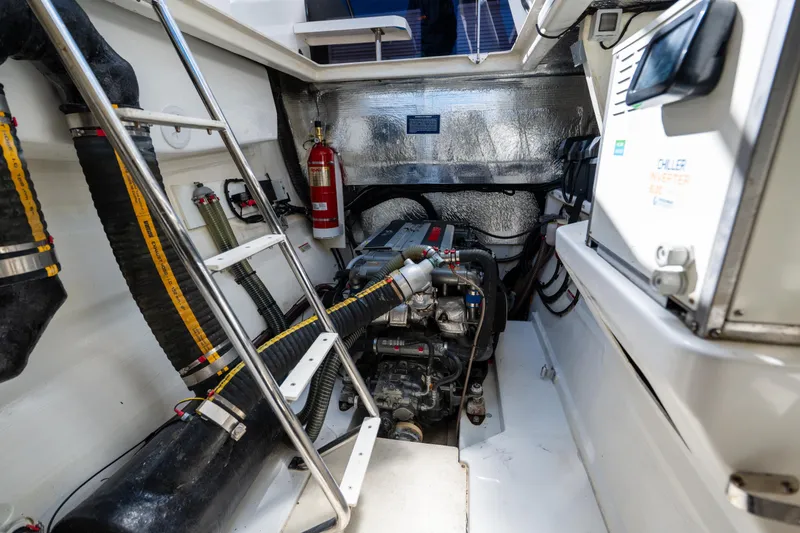 Slide: The Image of Engine room of 2021 Leopard 53 Powercat with visible machinery and fire extinguisher. - 16
