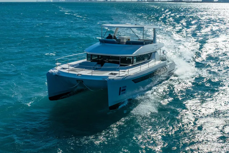 Slide: The Image of 2021 Leopard 53 Powercat cruising on open blue ocean waters. - 2