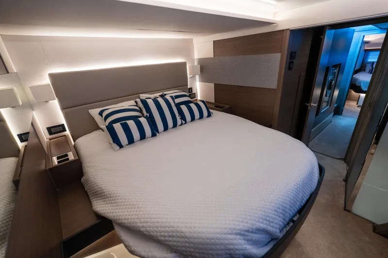Slide: The Image of Luxurious bedroom interior of 2021 Leopard 53 Powercat yacht with modern design and striped pillows. - 26