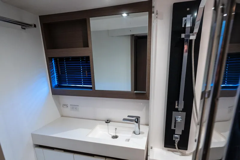 Slide: The Image of Modern bathroom interior of 2021 Leopard 53 Powercat yacht, featuring sleek sink and mirror. - 27