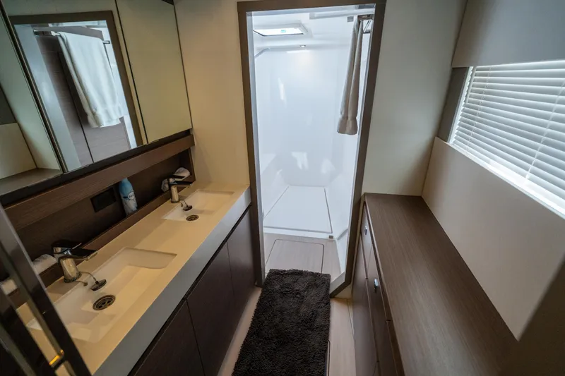 Slide: The Image of Modern bathroom interior of 2021 Leopard 53 Powercat yacht, featuring dual sinks and shower. - 32