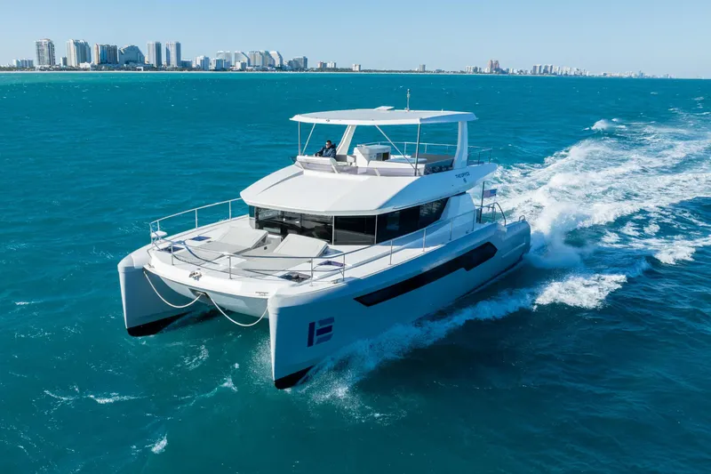 Slide: The Image of 2021 Leopard 53 Powercat cruising on blue ocean near city skyline. - 4