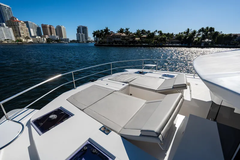 Slide: The Image of Leopard 53 Powercat 2021 yacht with sun loungers, city skyline, and waterfront view. - 45