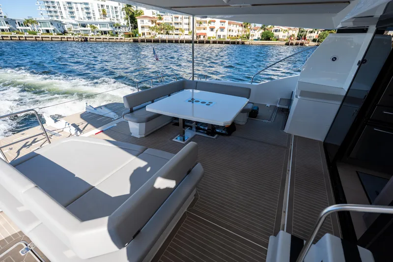 Slide: The Image of Luxurious 2021 Leopard 53 Powercat yacht deck with seating and table, cruising on water. - 47