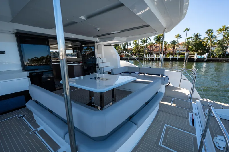 Slide: The Image of Luxurious 2021 Leopard 53 Powercat yacht with spacious outdoor seating and scenic waterfront view. - 50