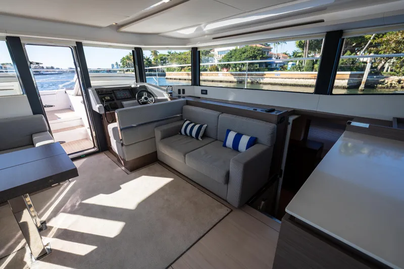 Slide: The Image of Interior of 2021 Leopard 53 Powercat yacht with modern seating and panoramic windows. - 52