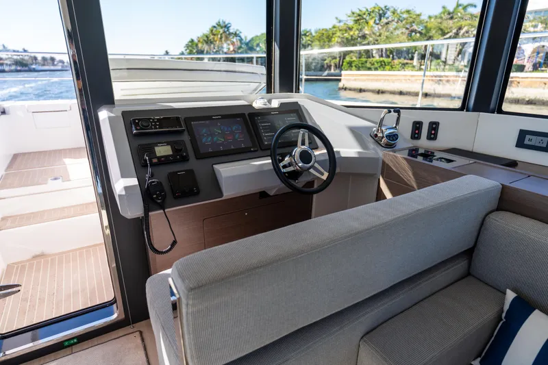 Slide: The Image of Interior helm of 2021 Leopard 53 Powercat with modern controls and comfortable seating. - 53