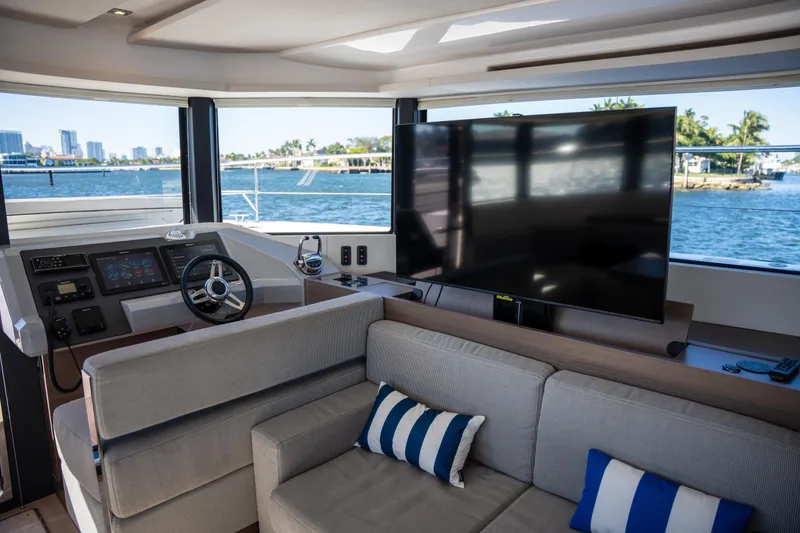 Slide: The Image of Interior of 2021 Leopard 53 Powercat yacht with helm, sofa, and large TV. - 54