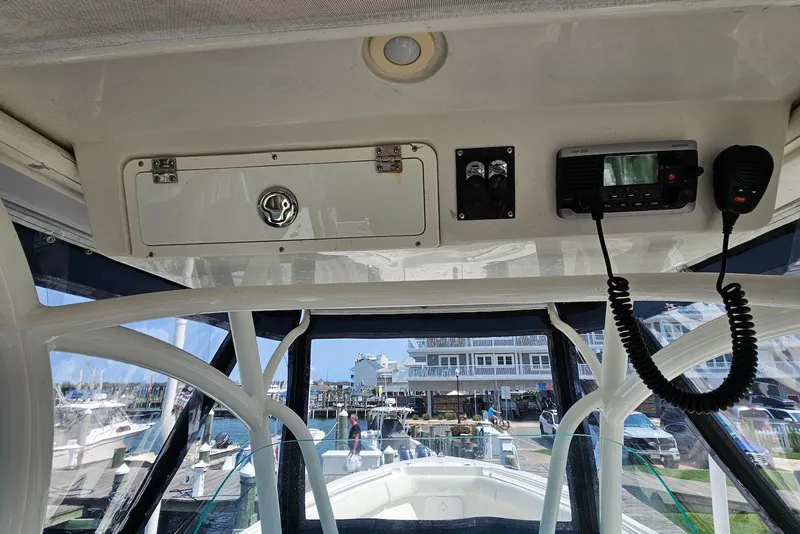 Slide: The Image of 2014 Sailfish 290 CC boat interior with control panel and radio equipment. - 17
