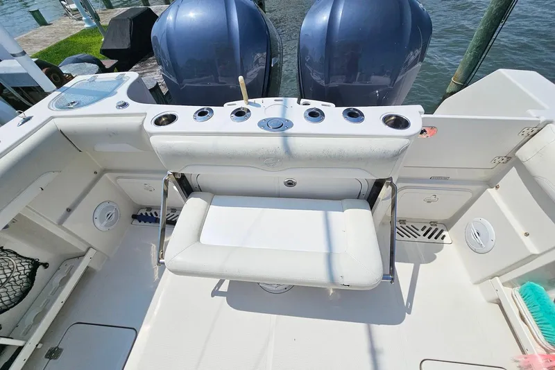 Slide: The Image of 2014 Sailfish 290 CC boat interior with seating and dual outboard motors. - 23