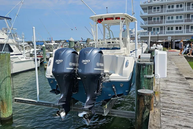 Slide: The Image of 2014 Sailfish 290 CC boat with twin Yamaha 300 V6 engines docked at marina. - 3