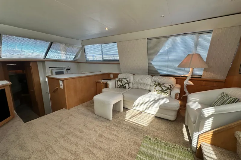 Slide: The Image of Luxurious interior of 1995 Carver 440 Aft Cabin Motor Yacht with plush seating. - 35