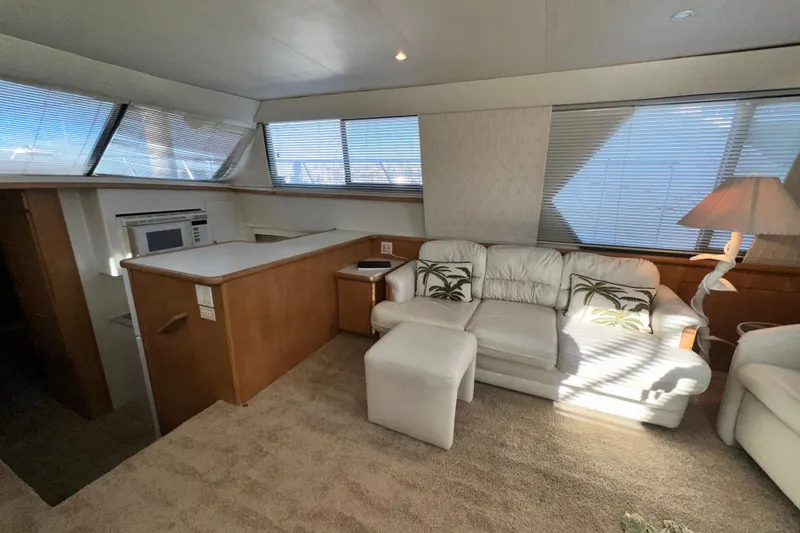 Slide: The Image of Interior of 1995 Carver 440 Aft Cabin Motor Yacht with white sofa and natural light. - 42