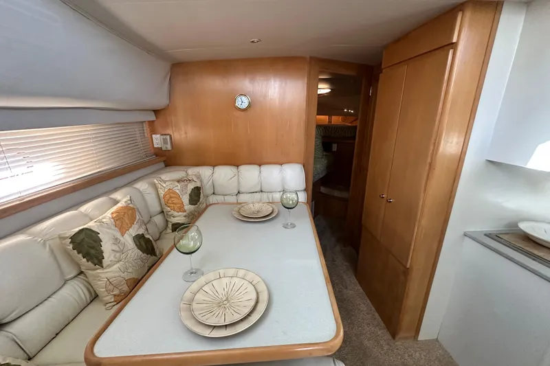 Slide: The Image of Interior of 1995 Carver 440 Aft Cabin Motor Yacht with dining area and cozy seating. - 47