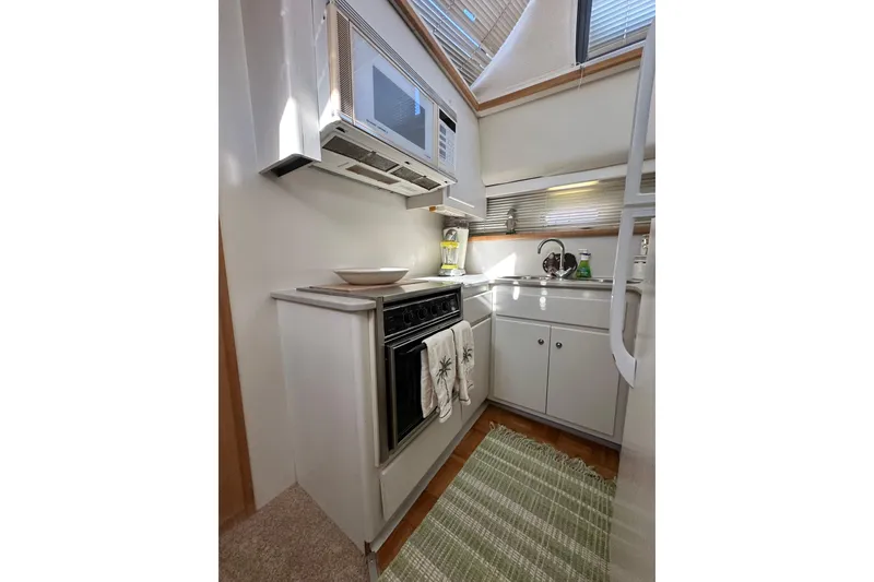 Slide: The Image of Compact kitchen in 1995 Carver 440 Aft Cabin Motor Yacht with modern appliances. - 51