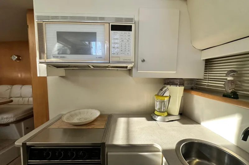 Slide: The Image of Compact kitchen in a 1995 Carver 440 Aft Cabin Motor Yacht with microwave and blender. - 54