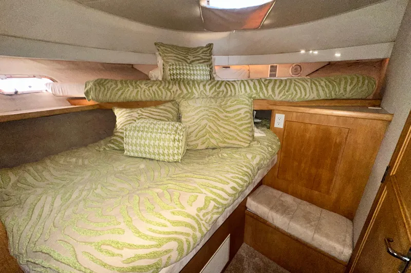 Slide: The Image of Cozy cabin interior of 1995 Carver 440 Aft Cabin Motor Yacht with patterned bedding. - 58