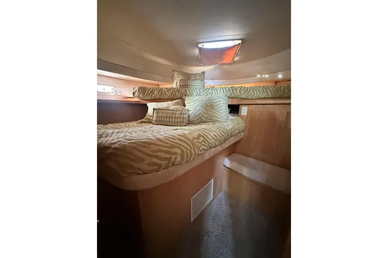 Slide: The Image of Cozy cabin interior of 1995 Carver 440 Aft Cabin Motor Yacht with patterned bedding. - 59