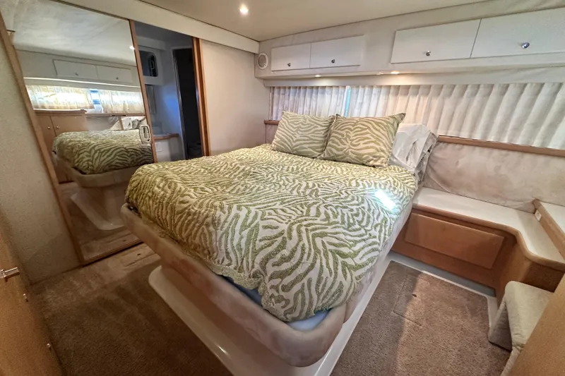 Slide: The Image of Interior of 1995 Carver 440 Aft Cabin Motor Yacht with cozy bedroom setup. - 65