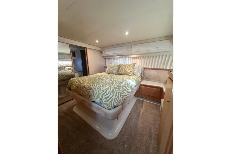 Slide: The Image of 1995 Carver 440 Aft Cabin Motor Yacht bedroom with cozy bed and elegant decor. - 66