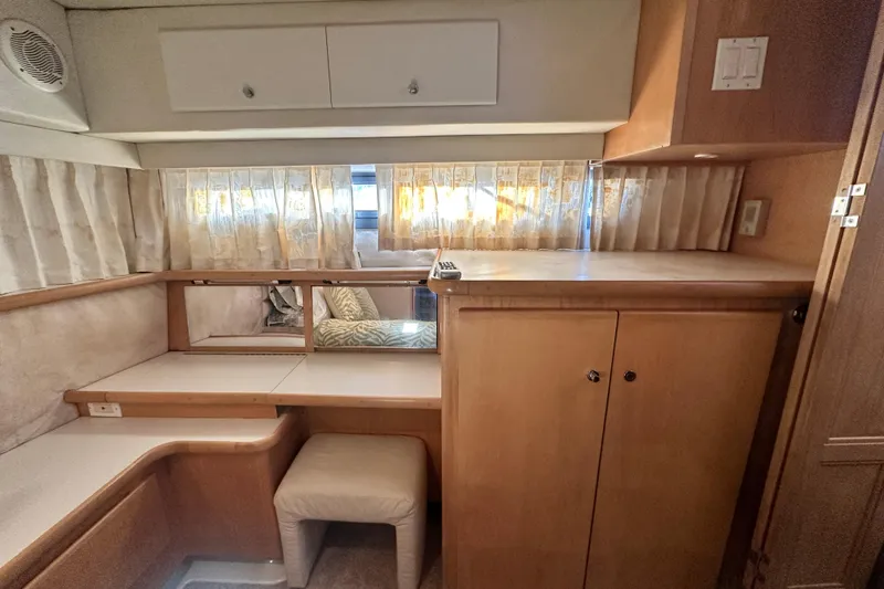 Slide: The Image of 1995 Carver 440 Aft Cabin Motor Yacht interior with wooden cabinetry and seating area. - 68