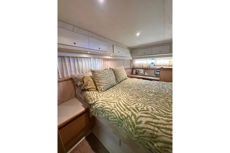 Slide: The Image of Cozy bedroom in 1995 Carver 440 Aft Cabin Motor Yacht with patterned bedding. - 72