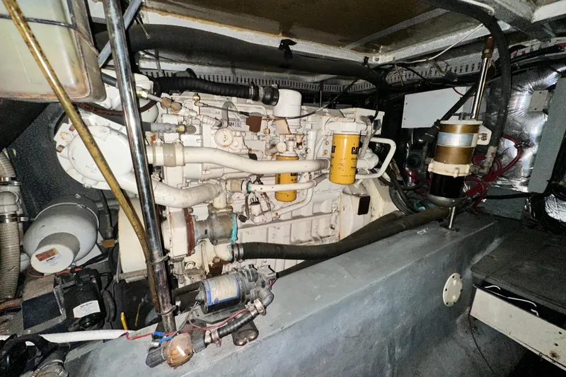 Slide: The Image of Engine room of a 1995 Carver 440 Aft Cabin Motor Yacht, showcasing mechanical components. - 81