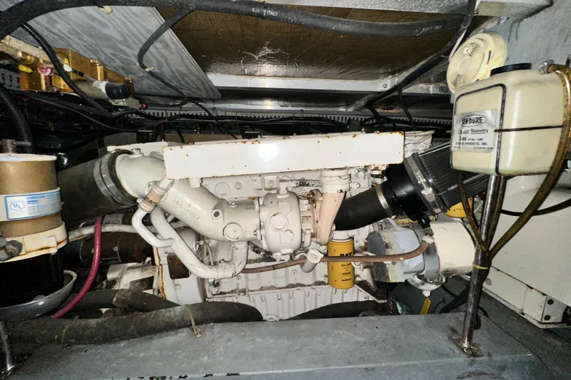 Slide: The Image of Engine room of a 1995 Carver 440 Aft Cabin Motor Yacht, showcasing mechanical components. - 85