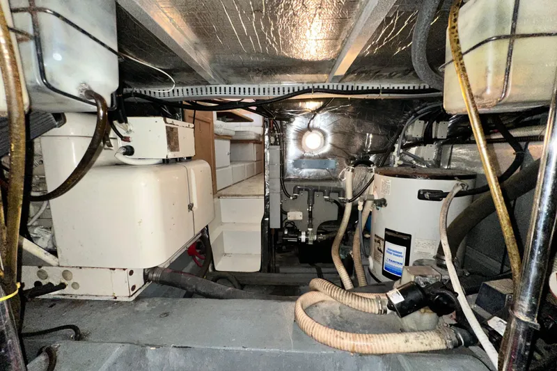 Slide: The Image of Engine room of a 1995 Carver 440 Aft Cabin Motor Yacht, showcasing equipment and wiring. - 86