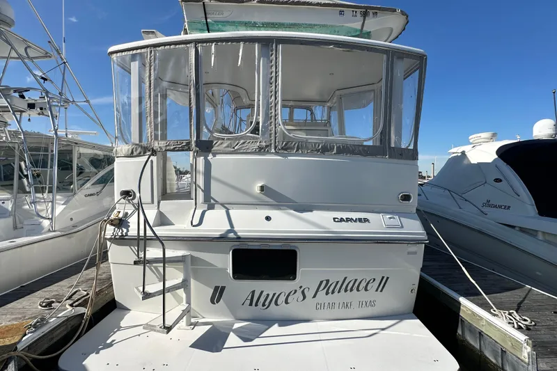 Slide: The Image of 1995 Carver 440 Aft Cabin Motor Yacht docked, rear view with name "Alyce's Palace II". - 9