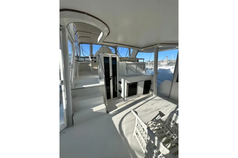Slide: The Image of 1995 Carver 440 Aft Cabin Motor Yacht interior with spacious seating and bright windows. - 15