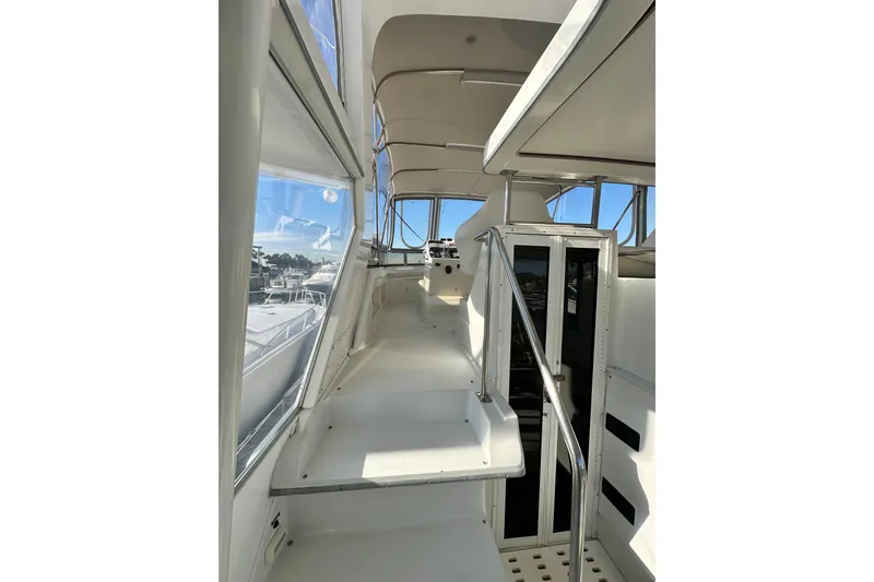 Slide: The Image of 1995 Carver 440 Aft Cabin Motor Yacht interior with sleek white design and panoramic windows. - 18
