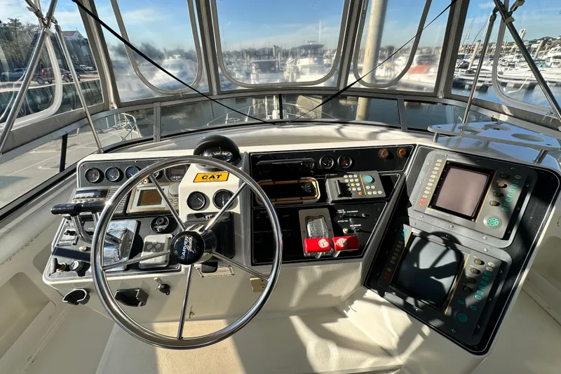 Slide: The Image of Cockpit of 1995 Carver 440 Aft Cabin Motor Yacht with steering wheel and navigation controls. - 25