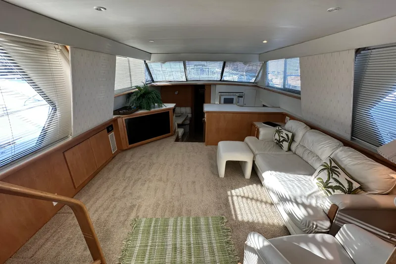 Slide: The Image of Luxurious interior of 1995 Carver 440 Aft Cabin Motor Yacht with plush seating and natural light. - 33